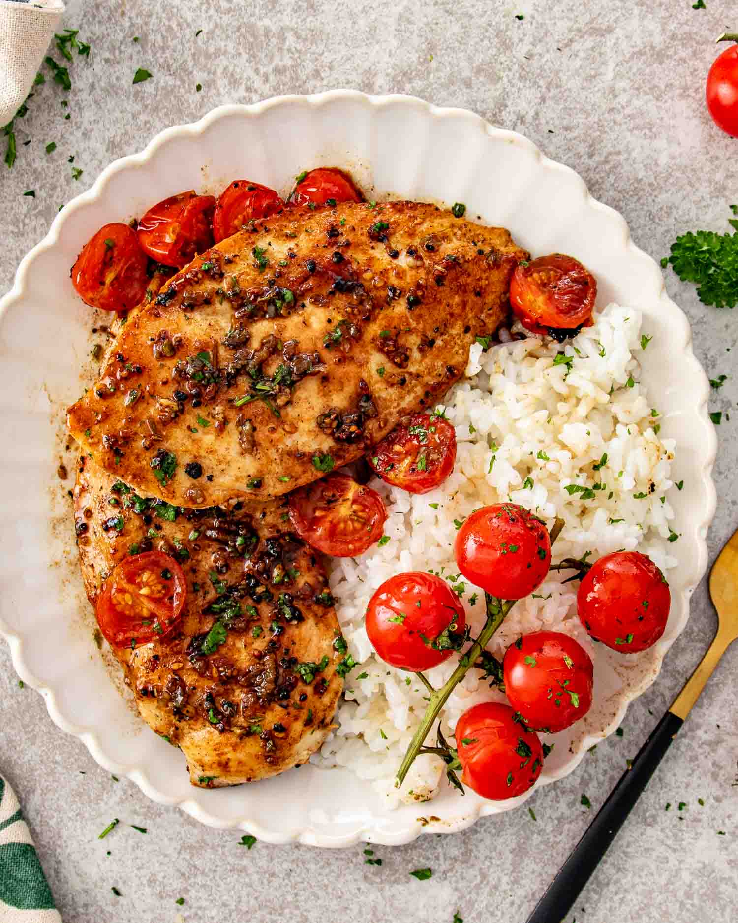 Balsamic chicken breasts served over fluffy white rice with roasted cherry tomatoes and a glossy garlic balsamic sauce.
