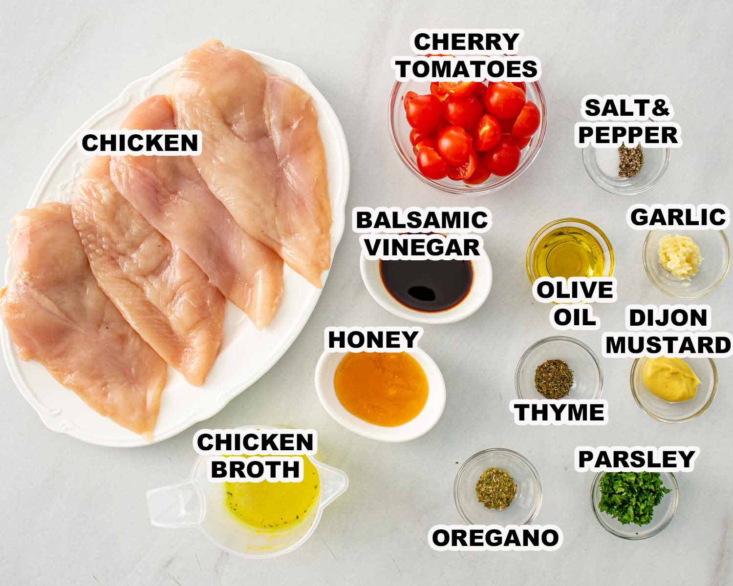 Raw chicken breasts with cherry tomatoes, balsamic vinegar, honey, garlic, Dijon mustard, herbs, olive oil, and chicken broth arranged neatly.