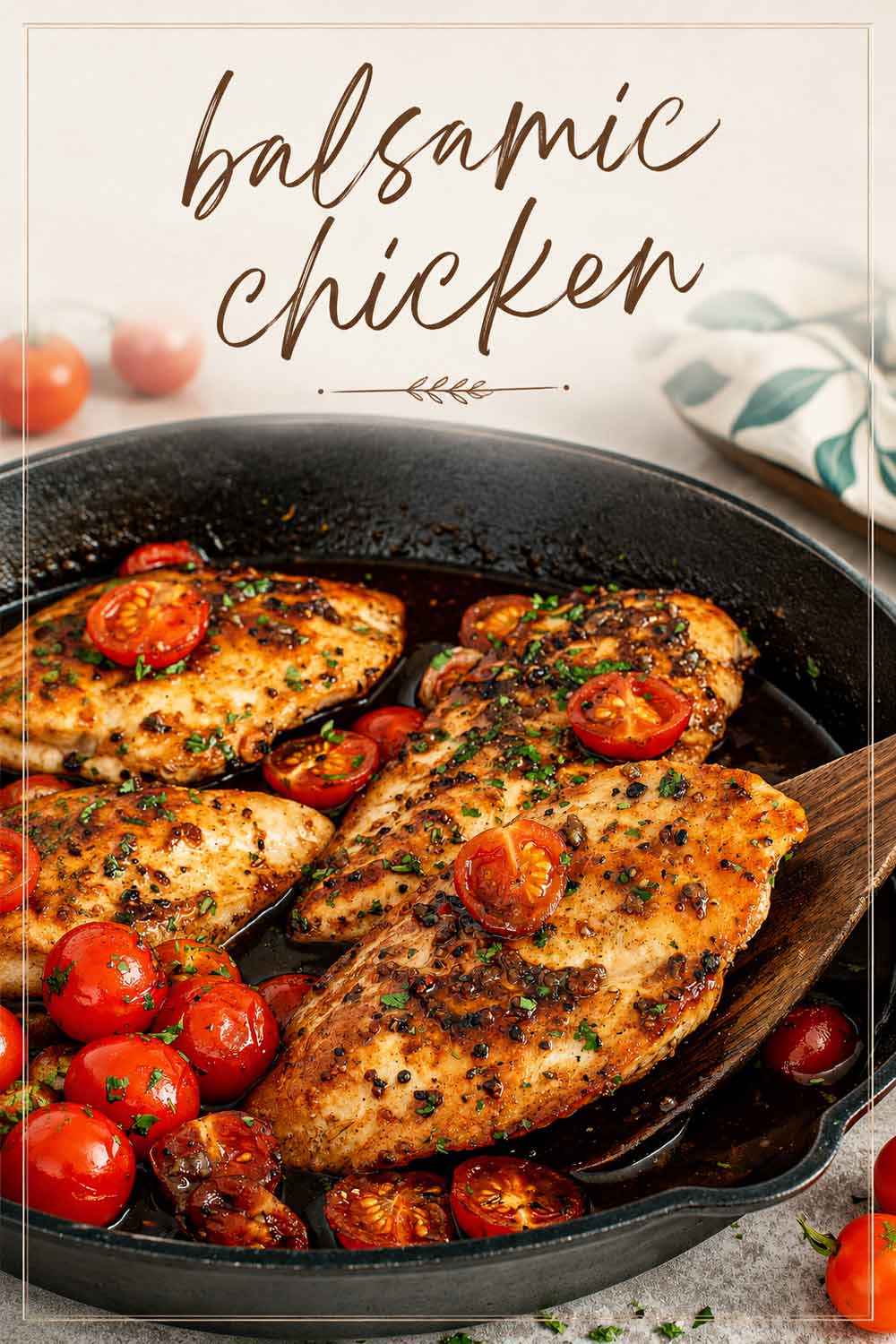 Juicy balsamic chicken breasts simmered in a cast iron skillet with blistered cherry tomatoes and fresh parsley garnish.