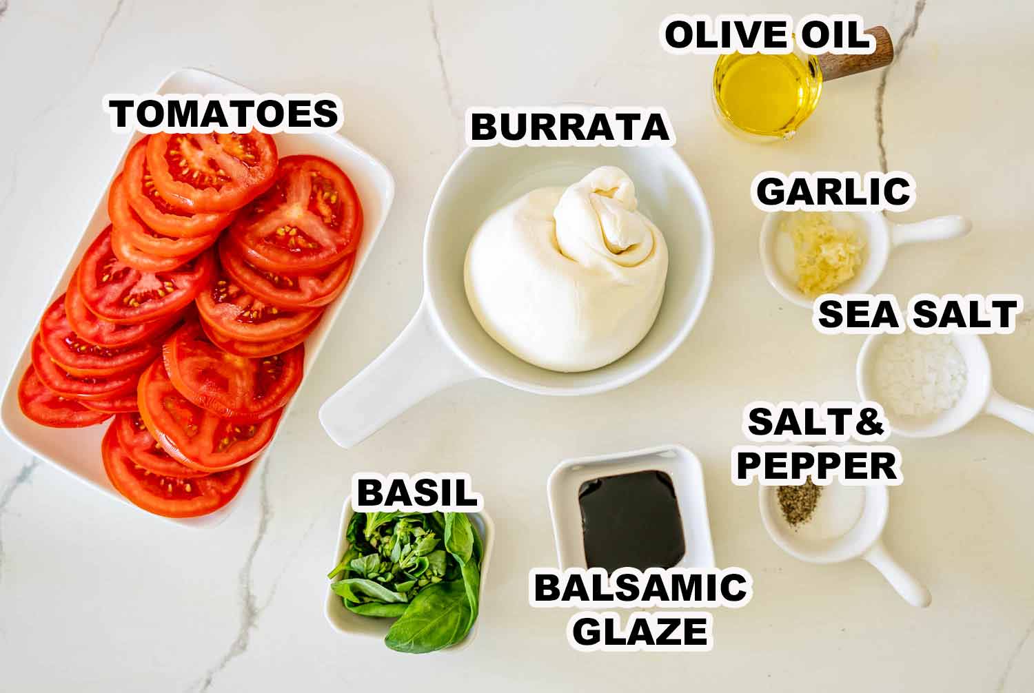 Ingredient shot featuring tomatoes, burrata cheese, basil, olive oil, garlic, balsamic glaze, sea salt, and black pepper.