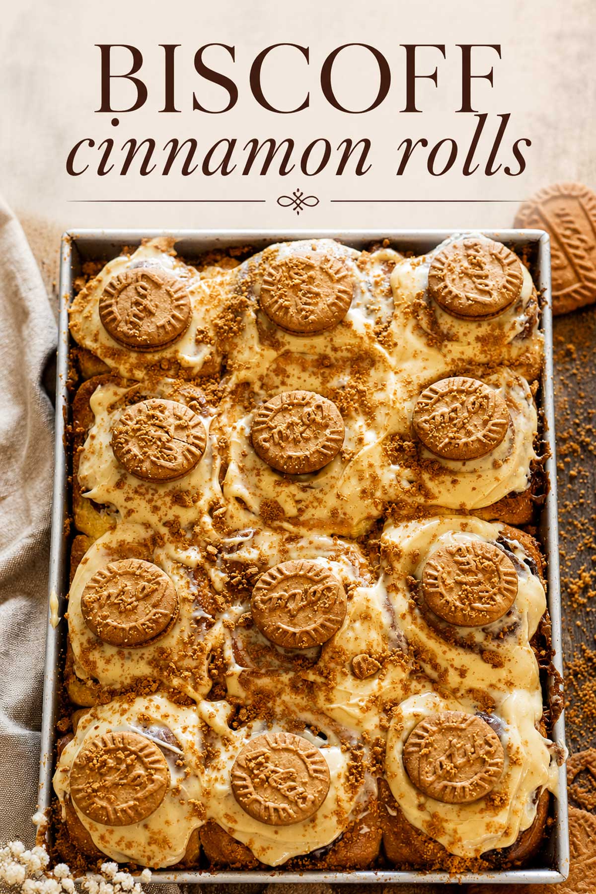 Pinterest image featuring Biscoff cinnamon rolls in a baking pan with elegant text overlay reading "Biscoff Cinnamon Rolls" on a soft neutral background.