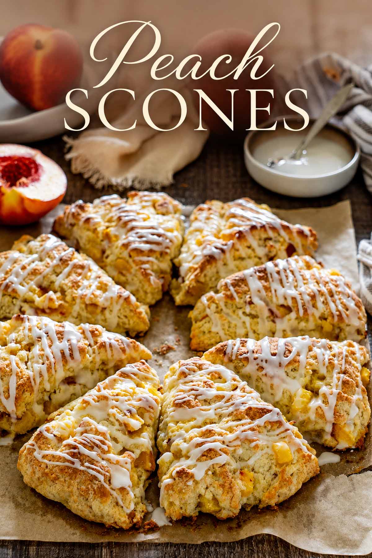 Glazed peach scones arranged on parchment with fresh peaches and an elegant Peach Scones title across the top.