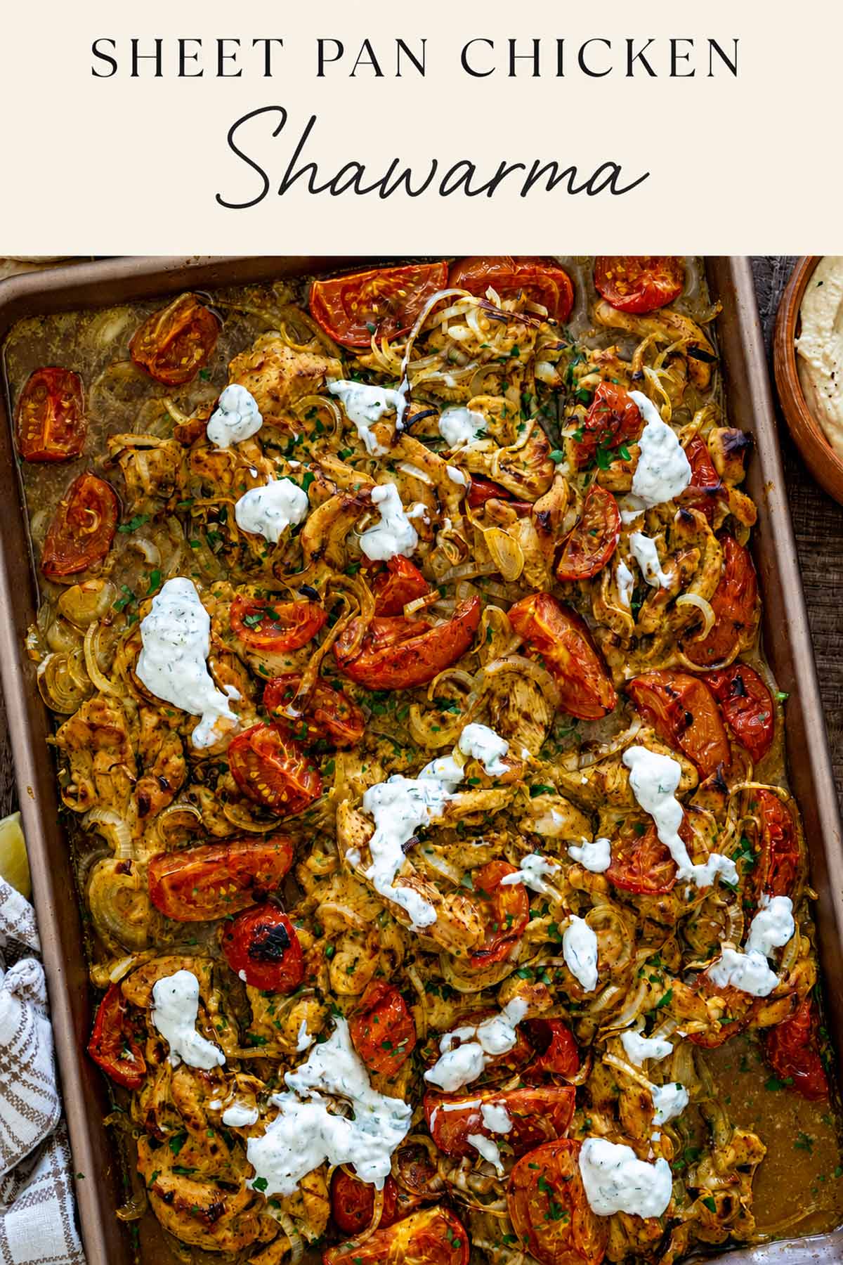 Pinterest graphic featuring sheet pan chicken shawarma with roasted tomatoes, onions, herbs, and creamy yogurt sauce drizzled over top.