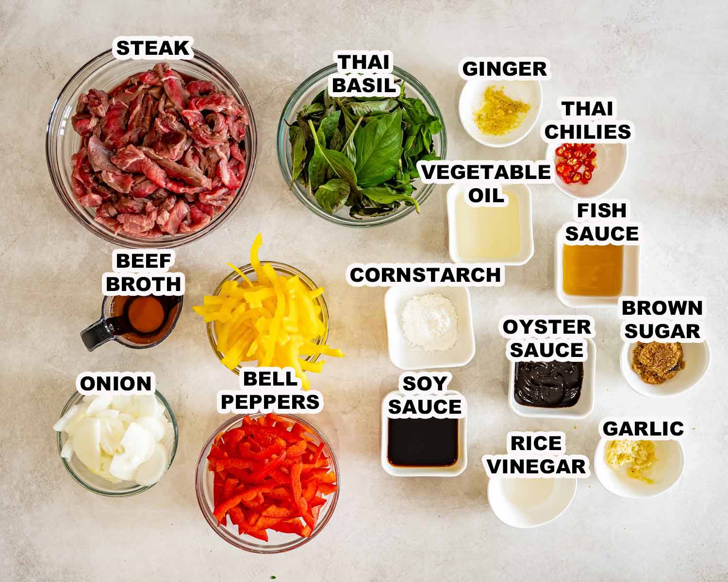 Labeled ingredients for Thai basil beef include steak, basil, bell peppers, onion, aromatics, broth, sauces, and seasonings.